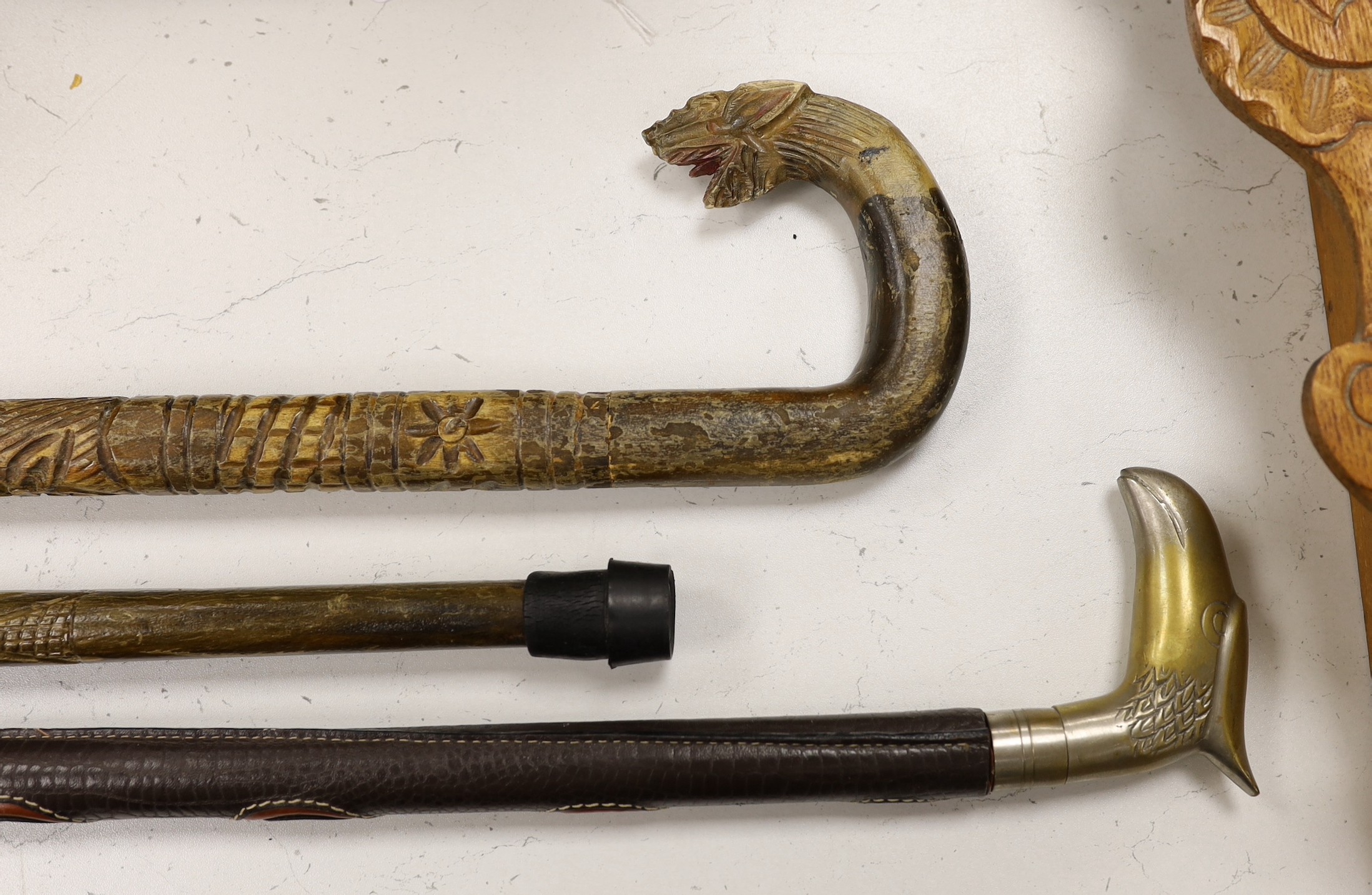 Three ornamental walking sticks. Largest 93cm tall